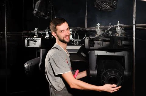 The stage worker sets up the lights. Stock Photos