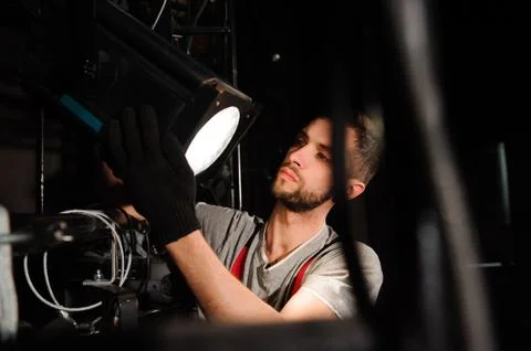 The stage worker sets up the lights. Stock Photos