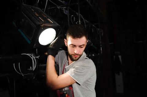 The stage worker sets up the lights. Stock Photos