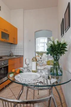 Staged Glass Dining Table with White Roses and Wine 스톡 사진