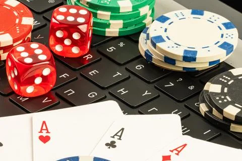 Staged image depicting gaming elements like playing cards, casino chips, an.. Stock Photos