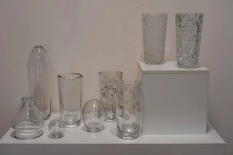 Stages of processing and drawing on crystal vases standing on a white bedsi.. 写真素材