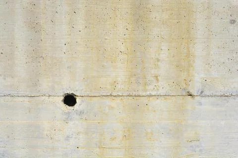 Stained concrete wall texture with round drainage hole Stock Photos