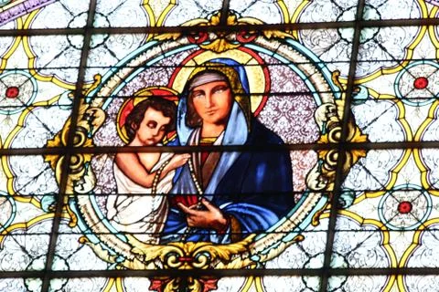 Stained glass depicting the virgin mary holding baby jesus Stock Photos