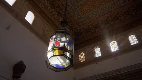 Stained Glass Lantern Illuminated by Sunlight in Ornate Marrakesh Interior Stock Footage 342182806