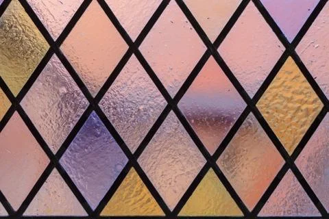 Stained glass with multi colored diamond pattern as background Stock Photos