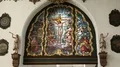 Stained-glass window with crucified Jesus and other saints, church interior HD Footage