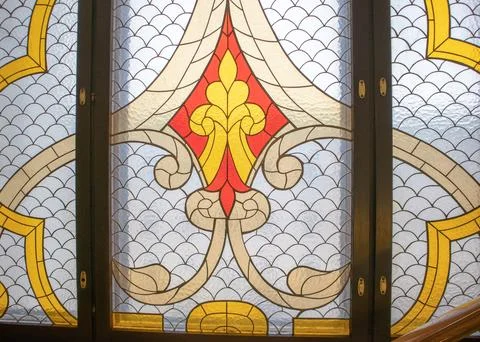 Stained glass window with gothic pattern and golden accents Stock Photos