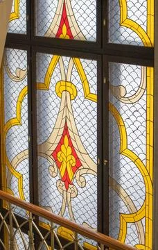Stained glass window with gothic pattern and golden accents Stock Photos