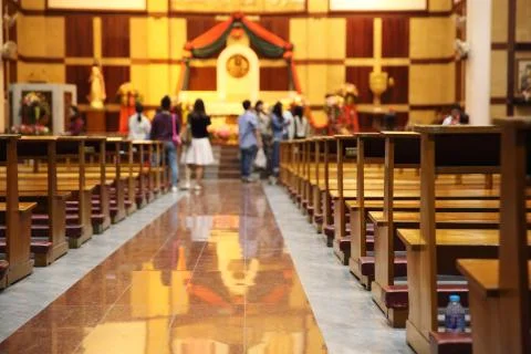 Stained glass windows in small church with wood pews Stock Photos