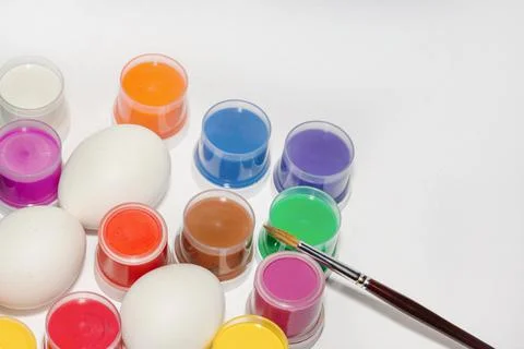 Staining fresh white eggs before Easter. Holiday preparation concept Stock Photos