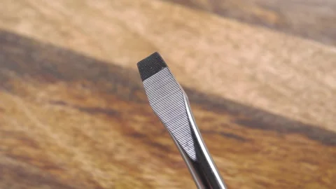 Stainless flat screwdriver head on a wooden background Stock Footage 159419219