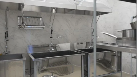 Stainless kitchen with marble walls and preparation sinks Stock-Footage 309771561