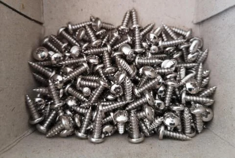Stainless self-tapping screws closeup in the paper box Stock Photos