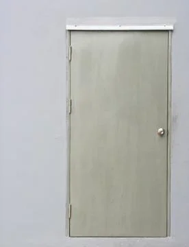 A stainless steel door on grey wall Stock Photos