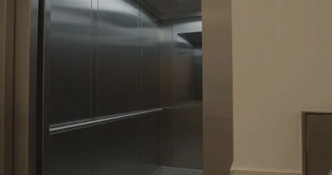 Stainless Steel Elevator Doors With Arrow, Modern Building Lobby, Slow Push In Stock Footage 340360555