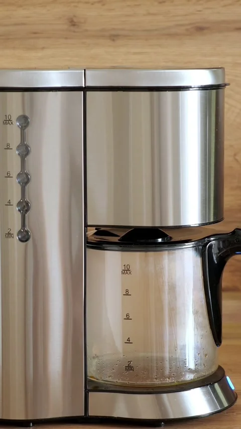 Stainless steel filter coffee machine brewing fresh aromatic hot coffee into the Video stock 341283668
