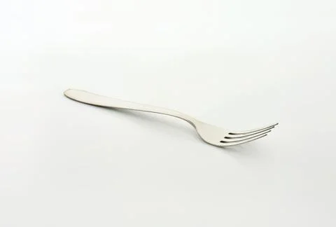 Stainless steel fork on clean surface Stock Photos