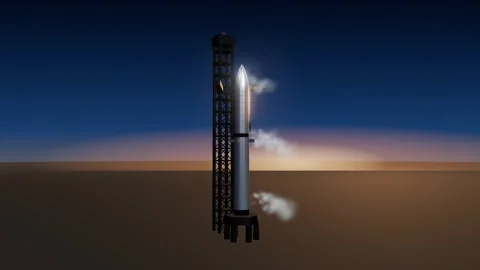 Stainless steel heavy rocket on launch pad beside catch tower at dawn with Stock Footage 339888277