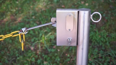 Stainless steel post with lock and chain Stock Footage 115417839