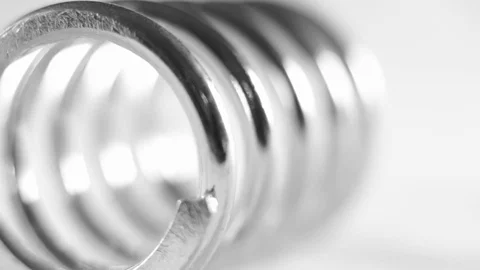 Stainless steel spring on bright background Stock Footage 83255669