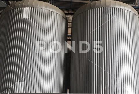Stainless steel tank at brewery for beer maturation Stock Photos