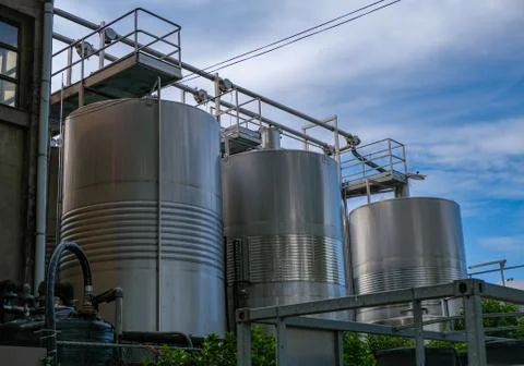Stainless tanks for processing and fermentation of grapes. Stock Photos