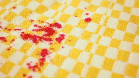 Stains on a yellow checkered cloth in a kitchen area 스톡 동영상 336474758