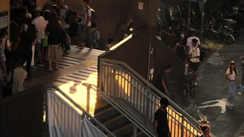 Stair from a train station when sun is setting, cigarette bin with smokers 06 Stock Footage 254239708