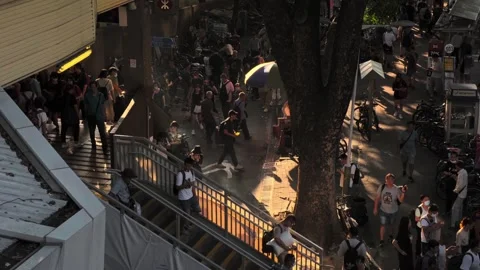 Stair of a train station when sun is setting, cigarette bin with smokers 01 Stock Footage 254239989
