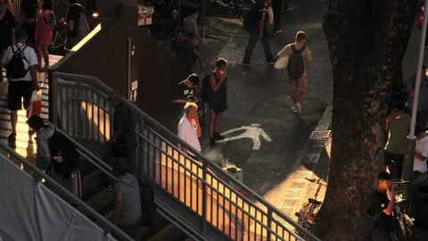 Stair from a train station when sun is setting, cigarette bin with smokers 05 Stock Footage 254240041