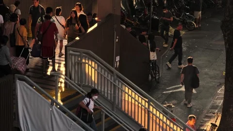 Stair from a train station when sun is setting, cigarette bin with smokers 09 Stock Footage 254333310