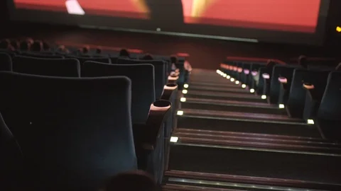 Staircase between seats rows in cinema. Unidentified film is on big screen Stock Footage 102645823