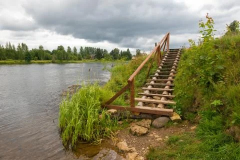 A staircase descends to the river. Stock Photos