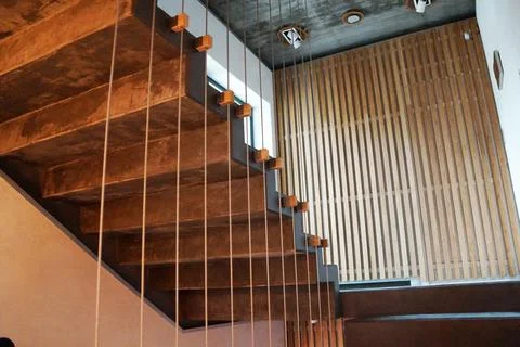 Staircase in the house with railing stretched from a cable Stock Photos