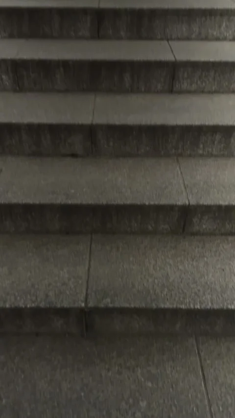 Staircase, long stone structure extending high, illuminated by bright modern Stock Footage 333512124