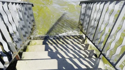 A staircase is shown with water splashing up from the steps 스톡 동영상 280338021