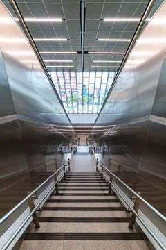 Staircase sided by two automatic escalators leading down to the main exit of  Stock-Fotos