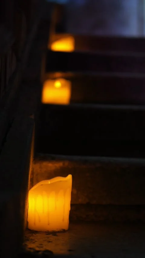 A staircase softly lit by candles, creating a serene ambiance with shadows Stock Footage 280349563