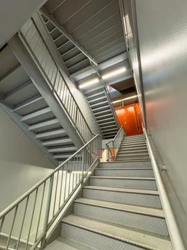 Staircase view in a building showing multiple levels and metal railings wit.. Stock Photos