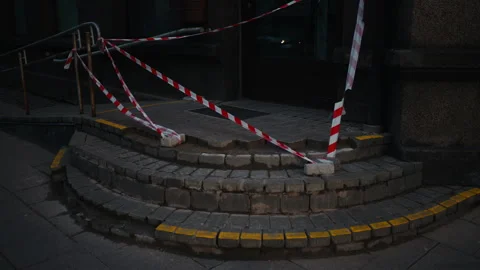 A staircase wrapped in red and white tape resembling an automotive tire pattern Video stock 271160178