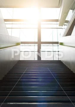 Stairs up inside the building and sun glare. Stock Photos