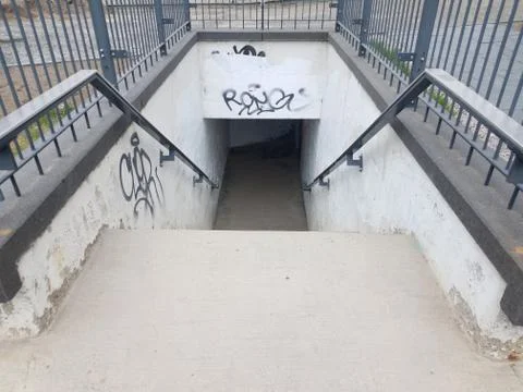 Stairs or steps leading down with railing and graffiti Stock Photos
