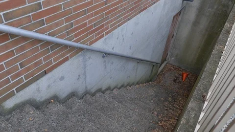 Stairs outside going down to door on building Stock Footage 125038729