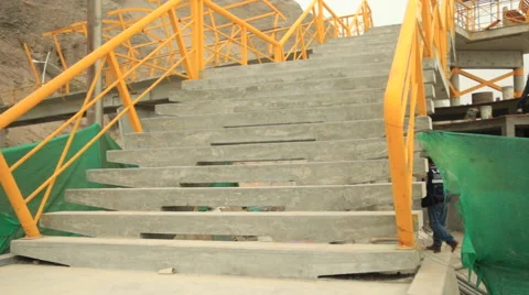 Stairs psychedelic railing to modern overpass, workers and bus in background Stock Footage 48915078