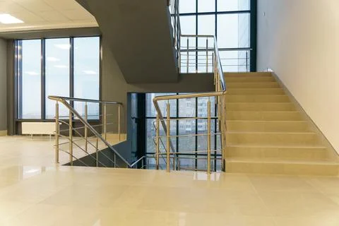 Stairwell in a modern building. An empty spacious hall with a flight of stair Stock Photos
