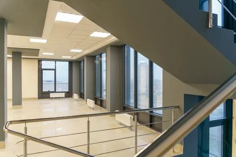 Stairwell in a modern building. An empty spacious hall with a flight of stair Stock Photos