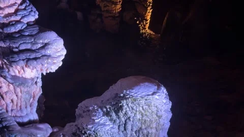 Stalactite and stalagmite formations inside a dark cave Video stock 340819285