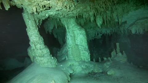 Stalactite columns rising from cave floor Stock Footage 331789243