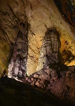 Stalactites and stalagmites colored by light in Yellow Dragon Cave in China Stock Photos